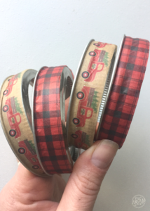 hand holding mason jar rings wrapped in washi tape