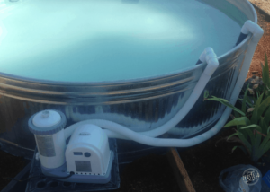 How to Create a DIY Stock Tank Pool: Filter and hoses connected to pool