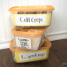 3 stacked and labeled seed storage bins