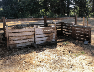 A 3-bin compost system with wood slat doors
