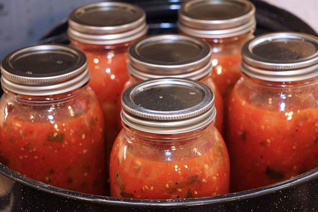 6 jars of tomatoes canned with citric acid, in a pot